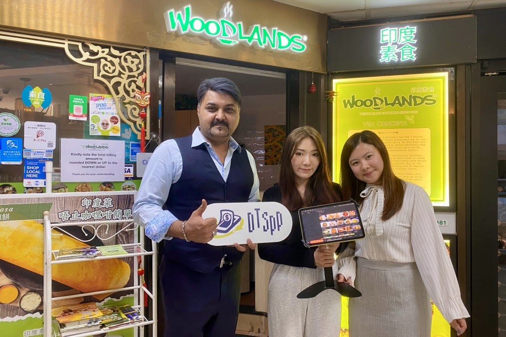 Alex P.E, Chairman of WOODLANDS Group of Restaurants in Hong Kong and Macau (left) is joined by Suki Shiu (centre) and Crystal Ngai (right) from Roka Service as they showcase the POS system adopted by the restaurant.