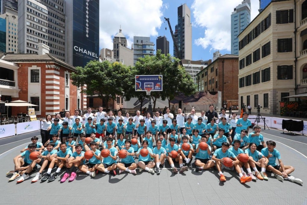 Officiating guests and other participants with young people at the kick-off ceremony of the Jockey Club Believe & Bounce Basketball Programme.