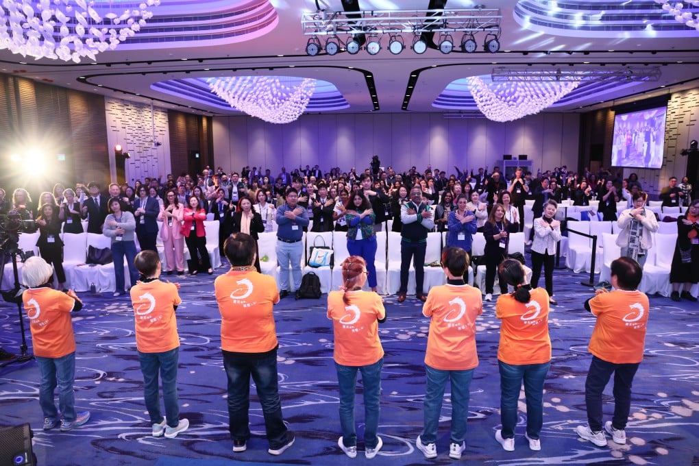 Delegates at the Inclusion Summit are engaged in learning sign language