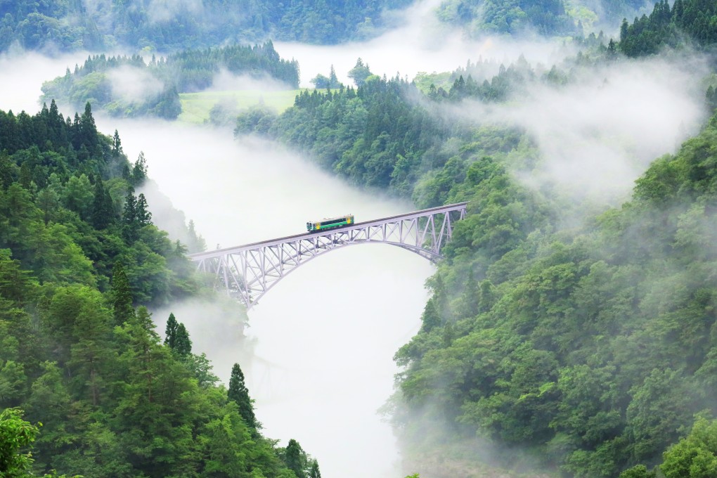 A train on the Tadami Line crosses the No 1 Tadami River Bridge between Aizu Hinohara and Aizu Nishikata in Japan. Photo: Ken Hoshi