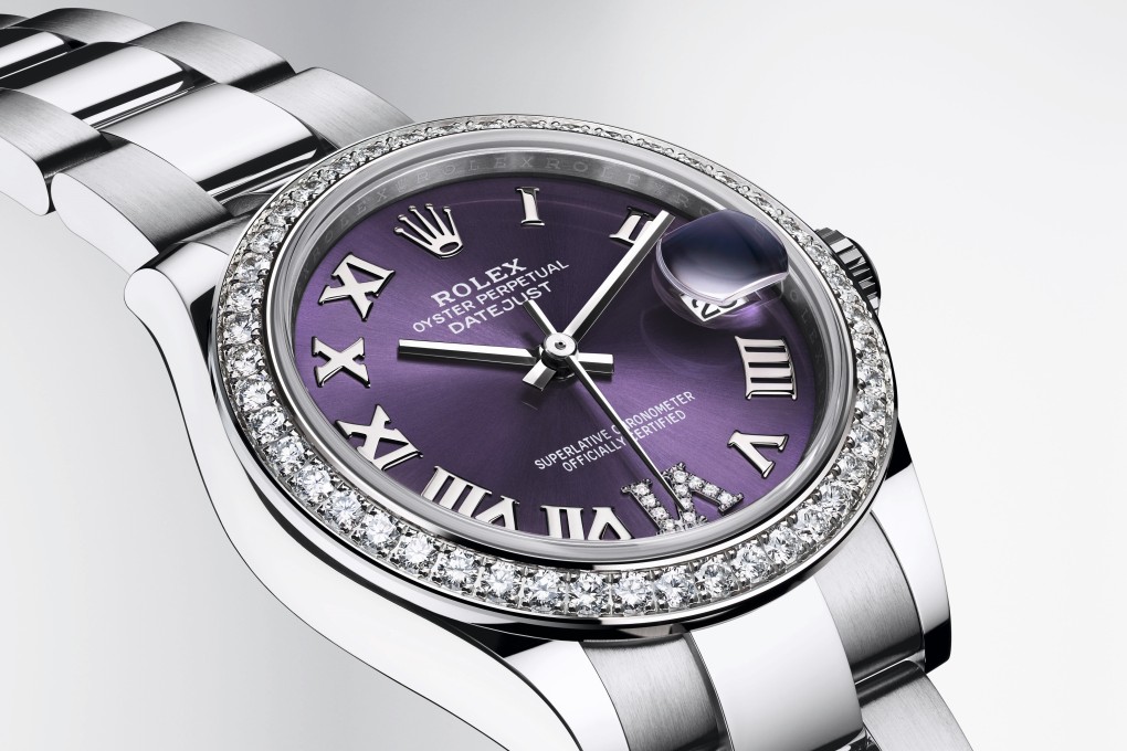 A Rolex Oyster Perpetual Datejust 31 with a bezel set with 46 brilliant-cut diamonds and an aubergine, sunray-finish dial with a diamond-set VI.