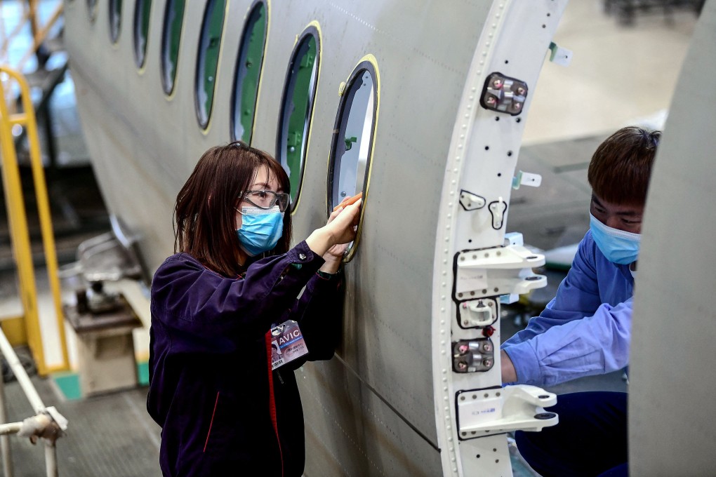 Chinese employees work on the fuselage of an aircraft at a factory in Shenyang. A Chinese women’s group are on a mission to end gender discrimination in the job marketplace. Photo: AFP