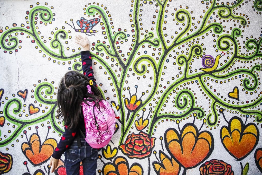 A child interacts with a mural in Kam Tin. Photo: SCMP / Winson Wong