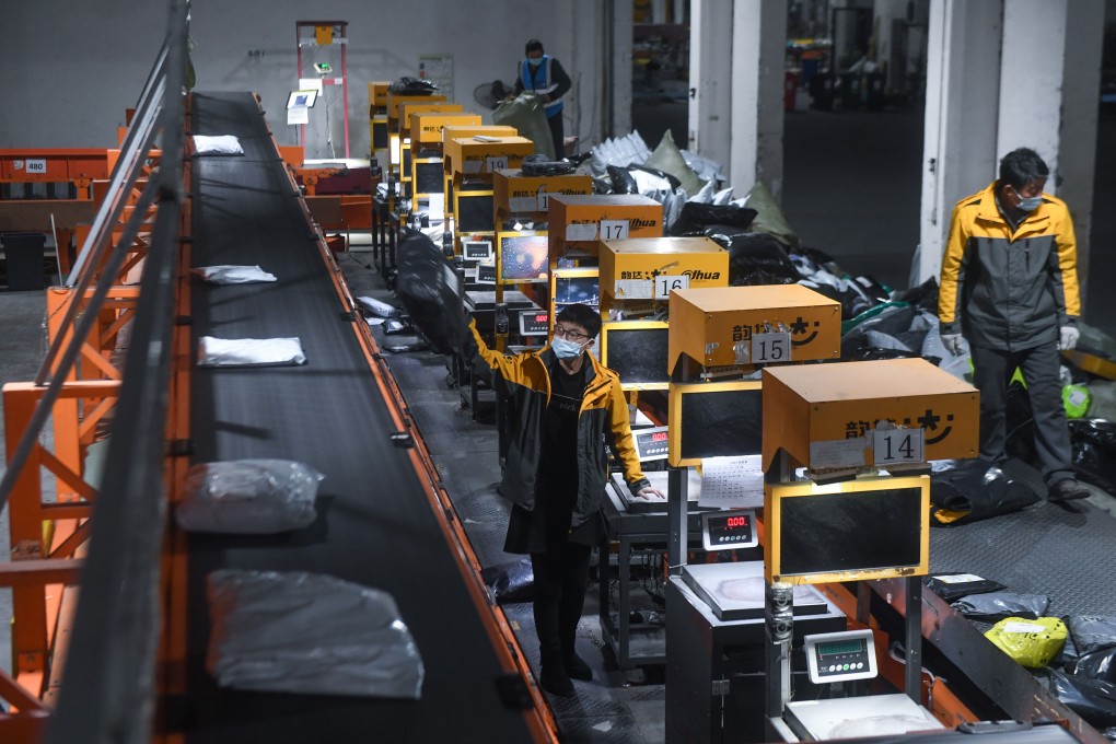 Staff sort packages at a warehouse of courier service provider Yunda Express in Zhili, Huzhou, eastern Zhejiang Province, on February 8. Following a resurgence in Covid-19 cases, China encouraged people to stay put over the Lunar New Year holiday to reduce the risk of infection, leading to a surge in online retail sales. Photo: Xinhua