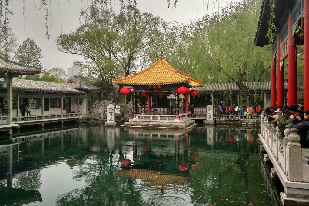 Tourists ring an ornamental pool at Baotu Spring Park, Jinan, Shandong province, in eastern China. A spokesman has appealed to visitors to end the practice of tossing coins in its waters for luck, saying they cause pollution. Photo: Shutterstock