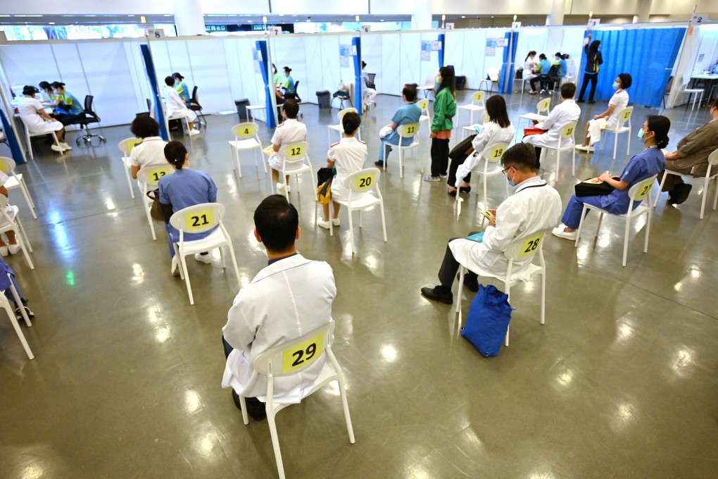 Doctors and nurses wait to receive the Sinovac vaccine at a community vaccination centre in Hong Kong on February 23. Photo: AFP/Bloomberg