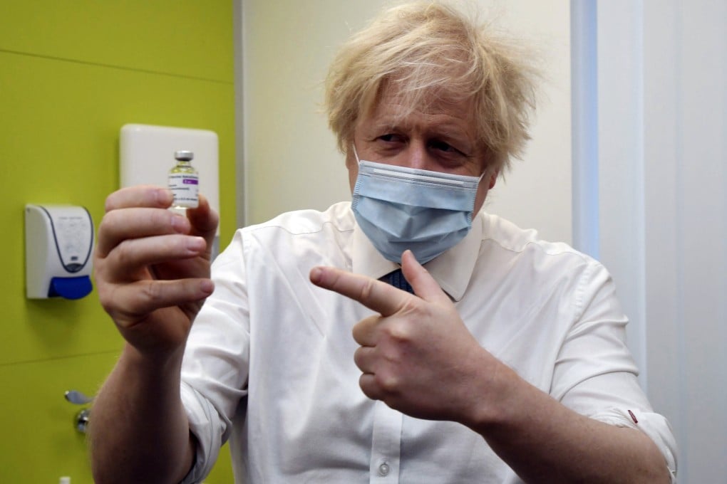 British Prime Minister Boris Johnson holds a vial of the AstraZeneca vaccine during a visit to a Covid-19 vaccination centre in Orpington, southeast London, on February 15. The country that just a few months ago was severely criticised for its botched handling of the pandemic is now being lauded for its success in administering vaccines. Photo: Pool Photo via AP