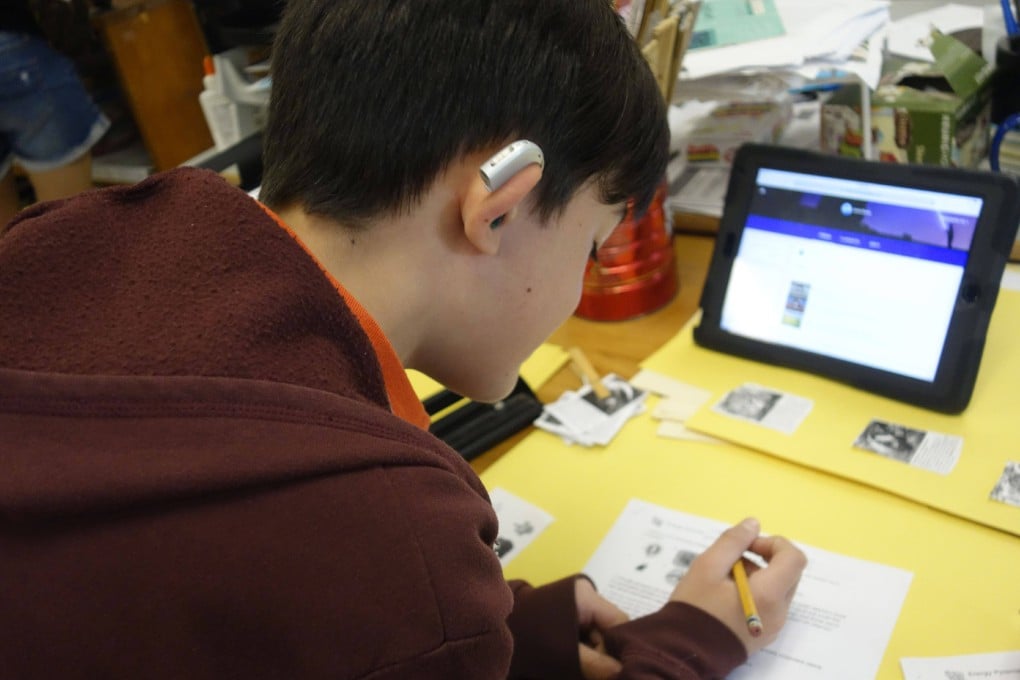 A boy with hearing difficulties does his school work. A World Health Organisation report has revealed that one in four people will suffer from hearing problems by 2050. Photo: Getty Images