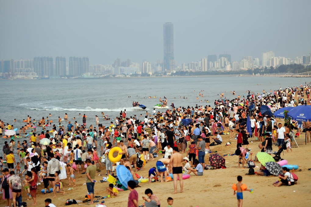 Tourists on a beach in Haikou, the capital of China’s Hainan province. Photo: Xinhua