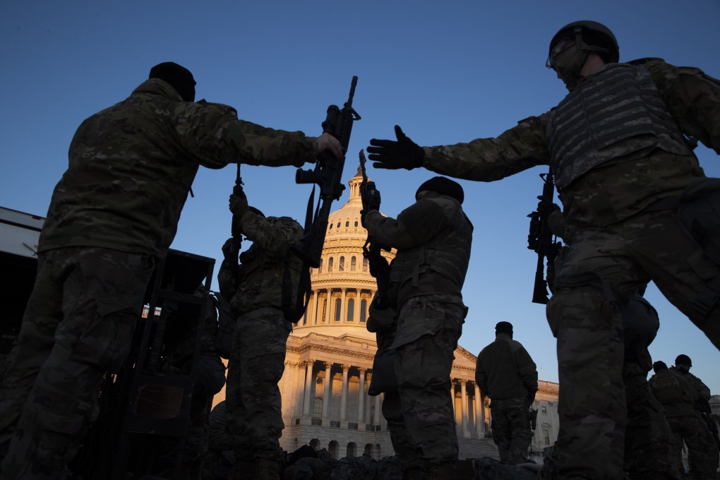 US National Guard troops are issued firearms at the East Front of the US Capitol in Washington on January 13, as thousands were deployed in Washington in the days leading up to the inauguration of US President Joe Biden. Photo: EPA-EFE