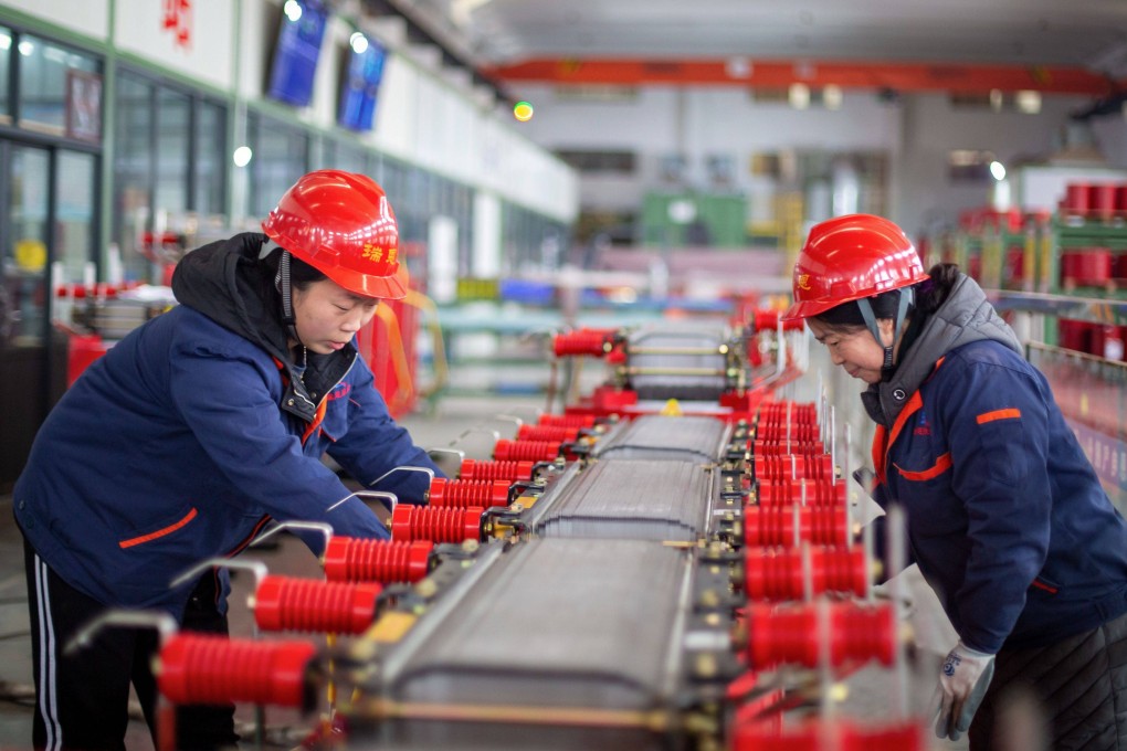 Employees work on a dry-type transformer production line at an electrical production factory in Haian in eastern China’s Jiangsu province. Photo: AFP