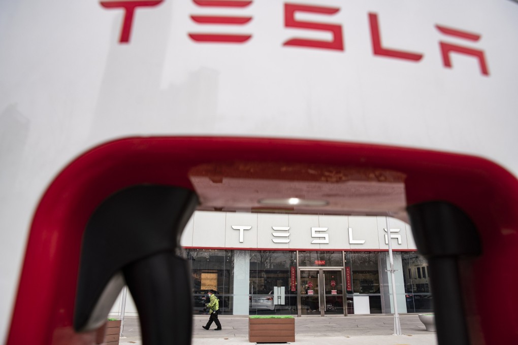 The Tesla Inc. logo is displayed on an electric vehicle charging station outside one of the companys showrooms in Beijing China, on Saturday, March 6, 2021. China, the worlds biggest car market, aims to boost auto sales and add more charging facilities for electric vehicles this year. Photographer: Qilai Shen/Bloomberg