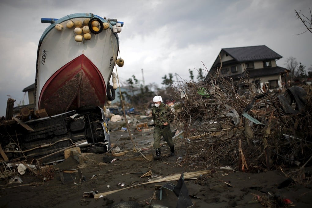 A ship washed up by the tsunami 10 years ago in a residential area of Ishinomaki in northern Japan. LIbrarians and museum curators are still archiving documents and artefacts that tell the story of the disaster. Photo: Reuters/Carlos Barria