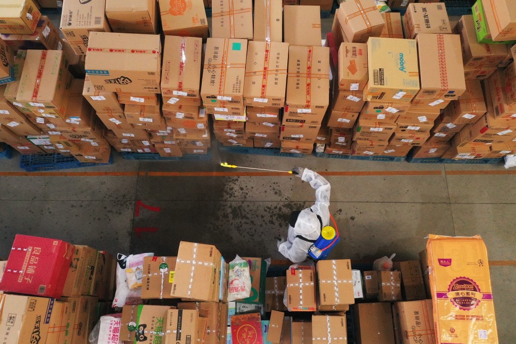 An employee disinfects packages at a distribution centre of Cainiao Network, the logistics affiliate of e-commerce giant Alibaba, in Shijiazhuang. Photo: Xinhua
