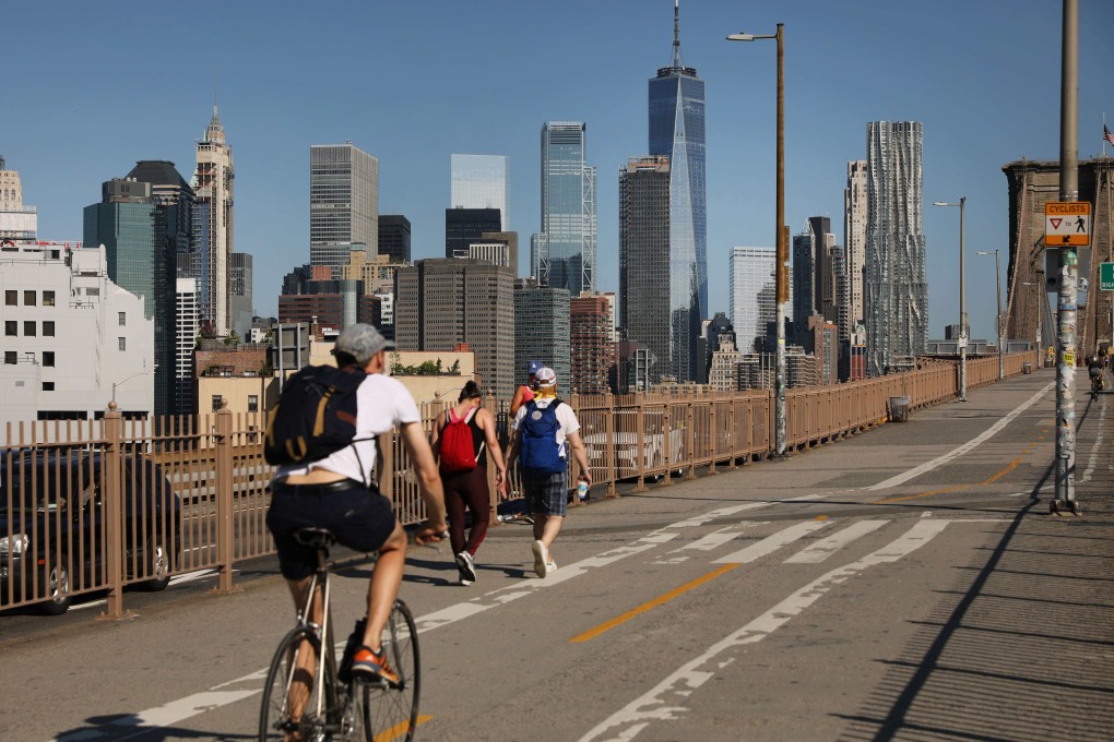 People walk and ride their bike across Brooklyn Bridge on June 22, 2020. The US has been investing a declining share of its GDP (2.3 per cent in 2017) in infrastructure. Photo: Getty Images/AFP