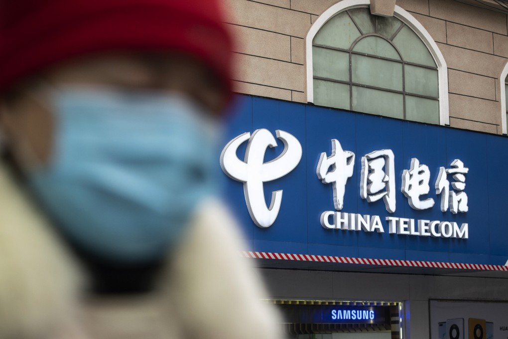 A pedestrian walks past a China Telecom shop in Shanghai on January 6, 2021. Photo: Bloomberg