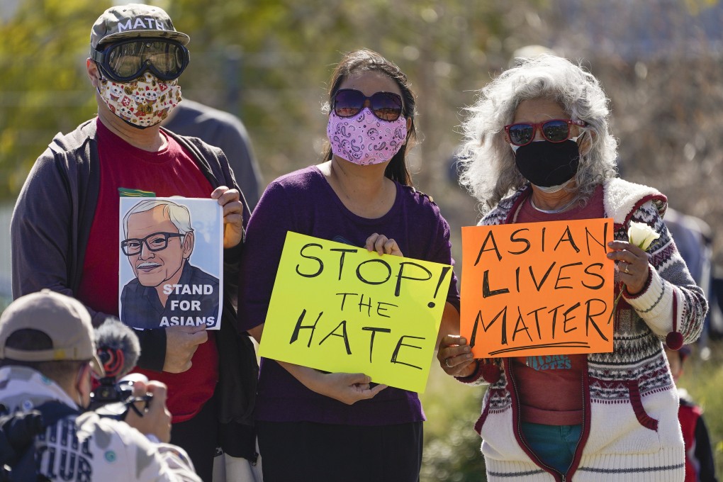 A man holds a portrait of the late Vichar Ratanapakdee, left, an 84-year-old immigrant from Thailand who was shoved to the ground in a deadly attack in San Francisco, during a rally to raise awareness of anti-Asian violence and racist attitudes at Los Angeles Historic Park near the Chinatown district in Los Angeles on February 20. Photo: AP