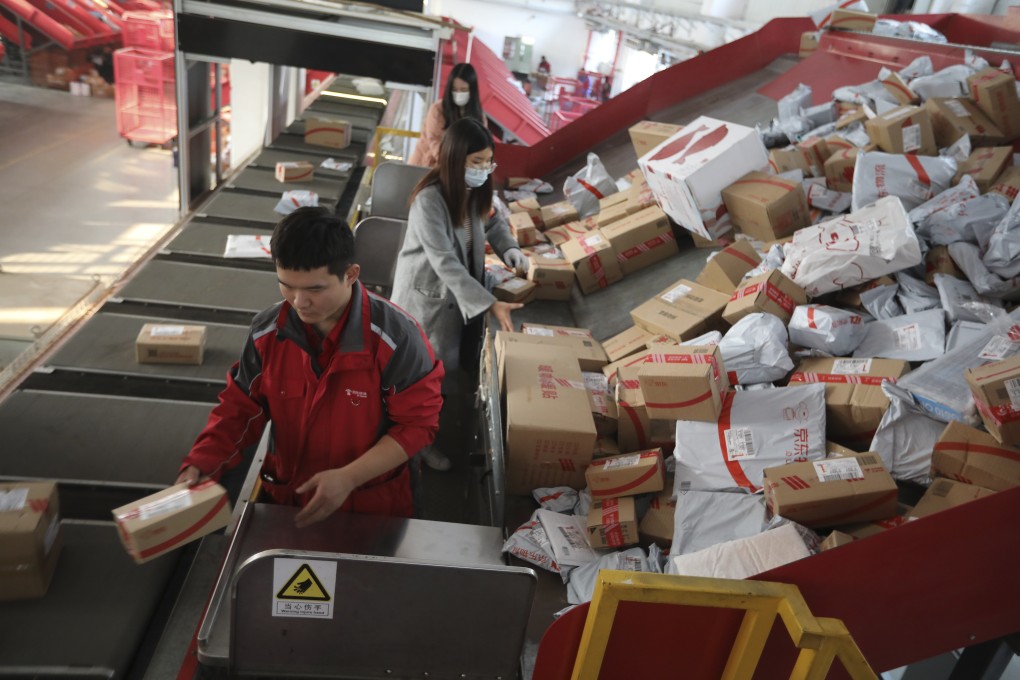 Workers sort out packages for delivery at JD.com’s Yizhuang Smart Delivery Station in Beijing on November 11, 2020. Photo: SCMP