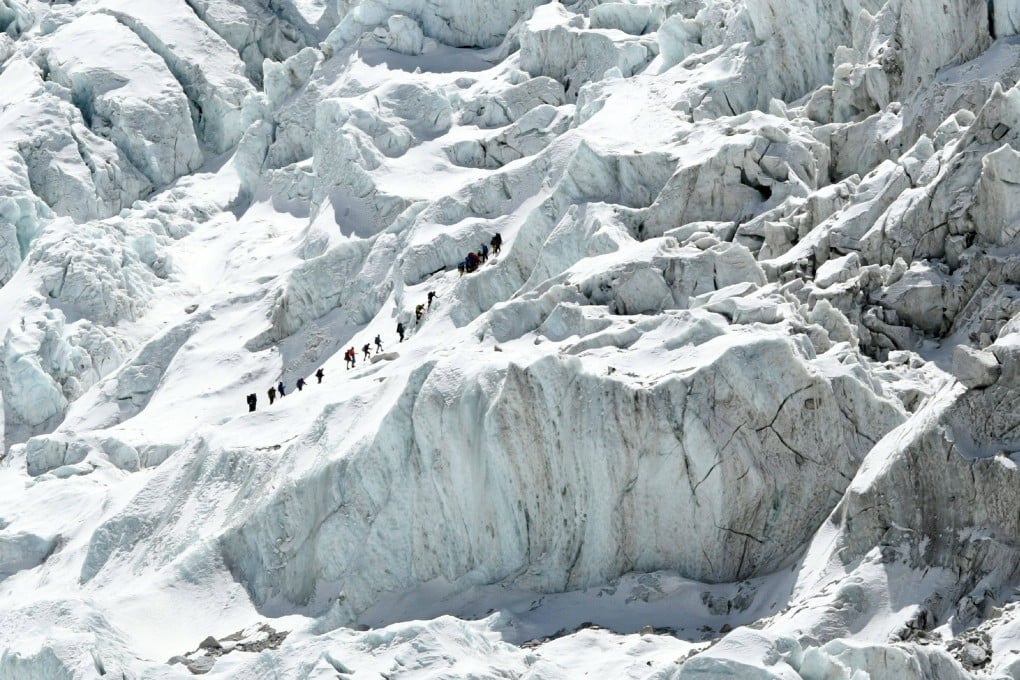 Climbers cross the Khumbu icefall of Mount Everest. The route across is prepared at the start of the climbing season by highly skilled Nepalese mountaineers. Photo: AFP/Prakash Mathema