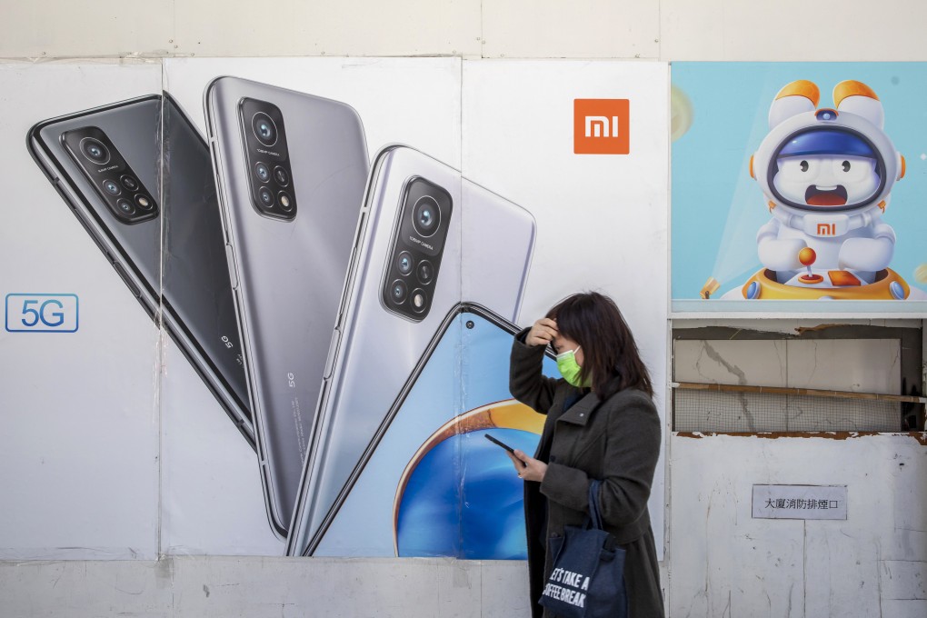 A pedestrian walks past advertisements at a Xiaomi Corp store in Hong Kong on December 2, 2020. Photo: Bloomberg