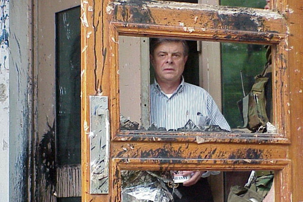 Then US ambassador to China James Sasser peers through a heavily-damaged door at the US embassy building in Beijing on May 10, 1999, following two days of attacks by Chinese protesters against Nato’s bombing of the Chinese embassy in Belgrade. Photo: Reuters