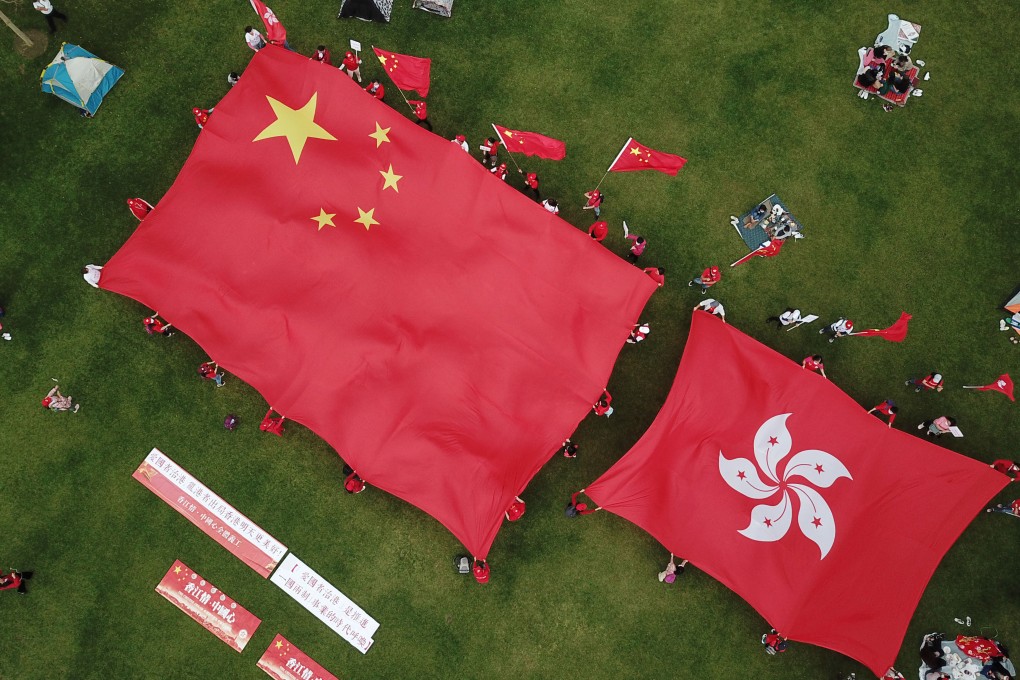 Hongkongers display the flags of China and Hong Kong in support of patriots governing Hong Kong, at Tamar Park on March 6. Photo: Xinhua