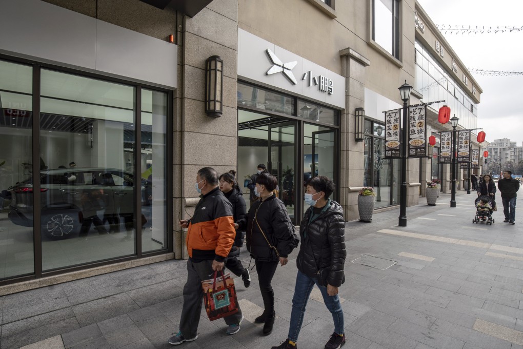 Shoppers walk past an XPeng showroom at the Chamtime Plaza in Shanghai. Photo: Bloomberg