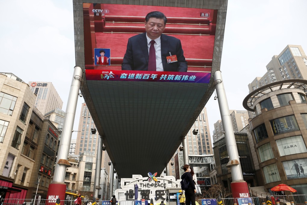A giant screen shows Chinese President Xi Jinping attending the closing session of the National Peoples Congress (NPC) at the Great Hall of the People, in Beijing on March 11. Photo: Reuters