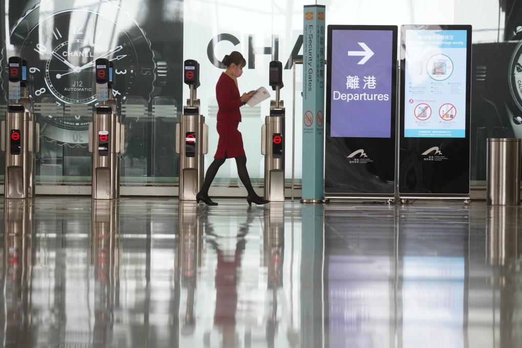 A member of Cathay Pacific’s ground support staff walks through a deserted Hong Kong International Airport at Chek Lap Kok on March 10. Photo: Winson Wong