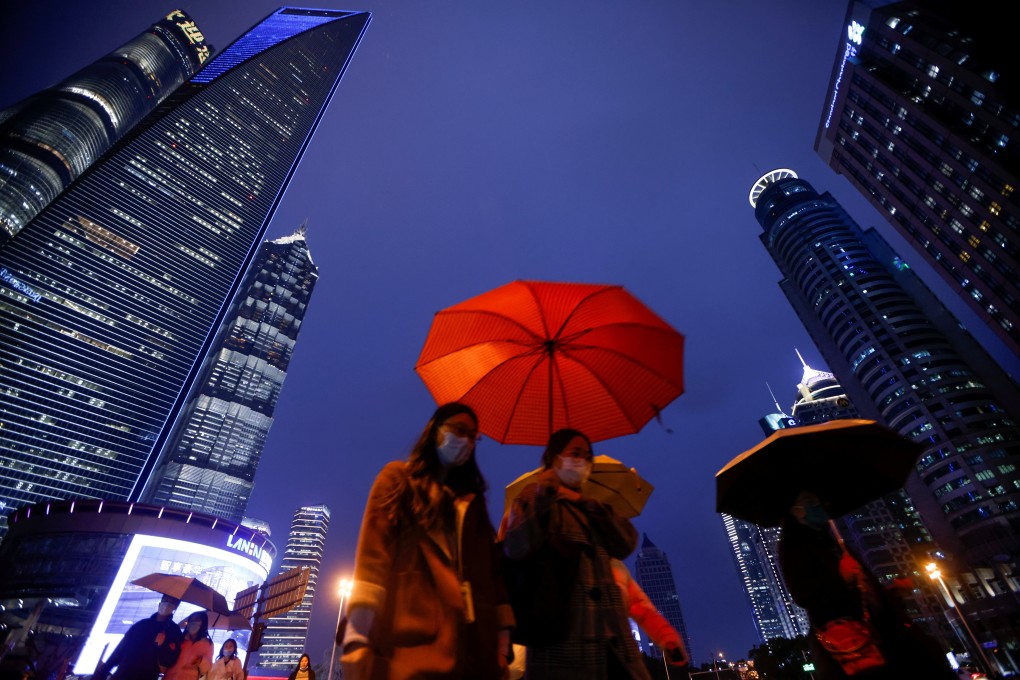 People walk with umbrellas in Lujiazui financial district in Pudong, Shanghai, on March 5. Photo: Reuters