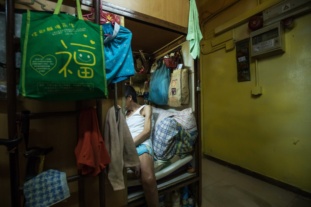 A tenant rests in his subdivided flat in Hong Kong, a city consistently ranked as the least affordable in the world for more than a decade. Photo: Bloomberg