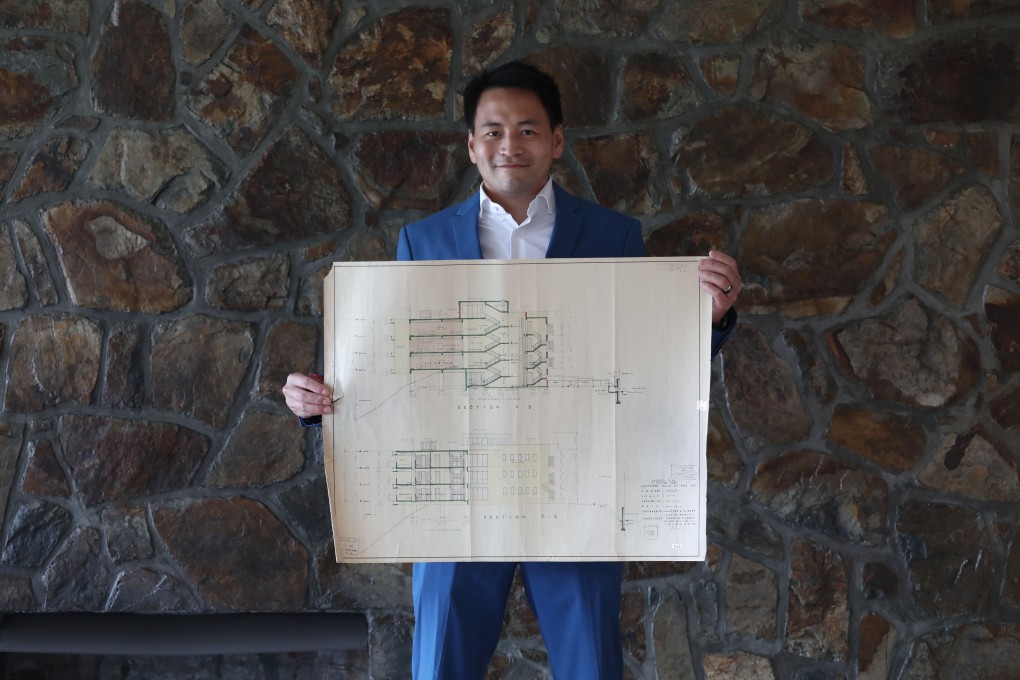 Wong Chin-yee, the general manager of Pokfulam Development, poses with architect Jackson Wong’s original 1950s blueprint of The Cove at 4 Headland Road. Photo: Jonathan Wong