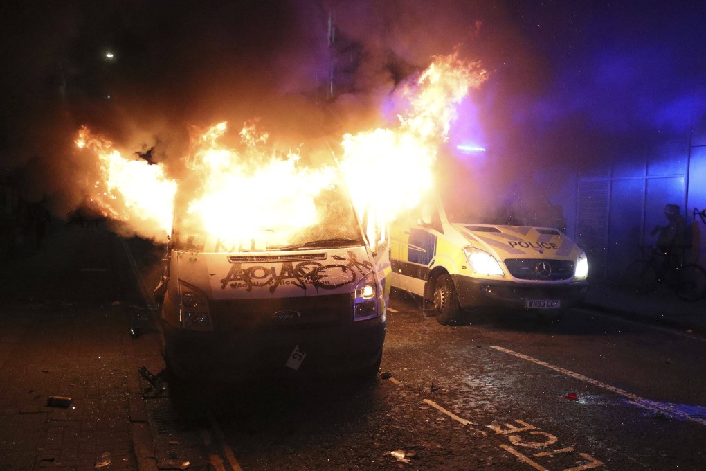 A vandalised police van on fire outside a police station in Bristol, England, on March 21, during protests against a controversial policing bill granting officers greater powers to crack down on protesters. Photo: AP