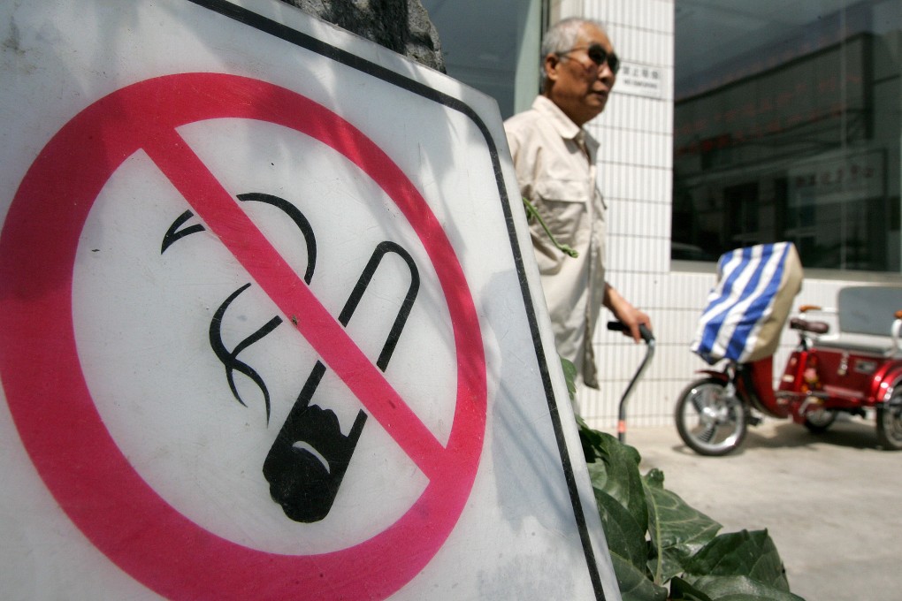A man walks past a no smoking sign in Beijing. China, which has around 300 million smokers, is considered the world’s largest market for tobacco products. Photo: AFP