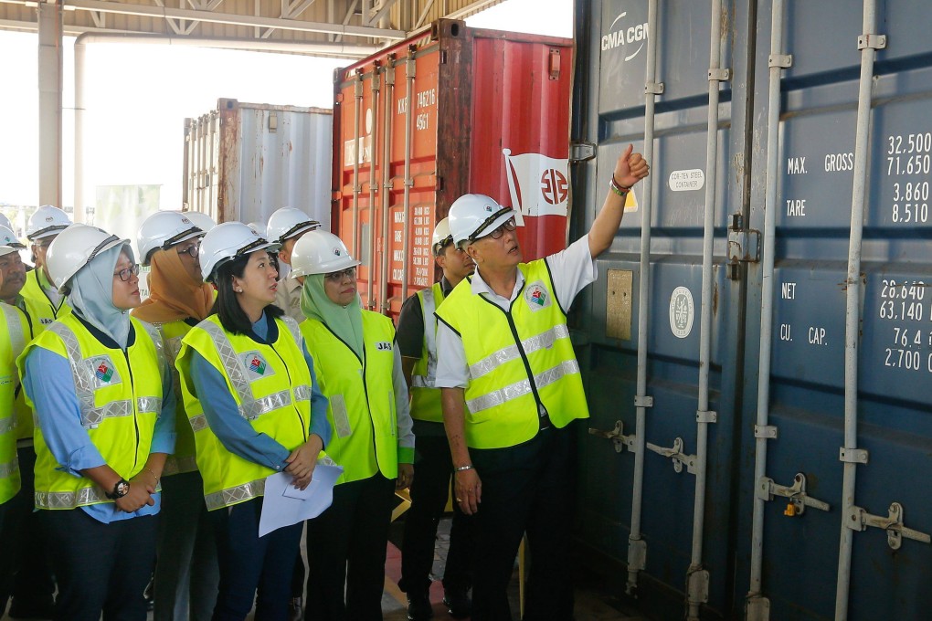 Malaysian Environment Minister Yeo Bee Yin and other officials inspect a container containing plastic waste last year. Photo: AFP