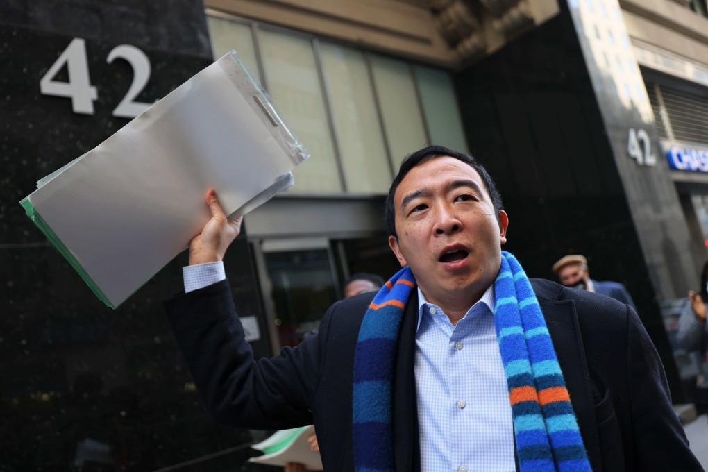 New York City mayoral candidate Andrew Yang holds up his campaigns petition signatures as he speaks outside the NYC Board of Elections office on Tuesday. Photo: AFP