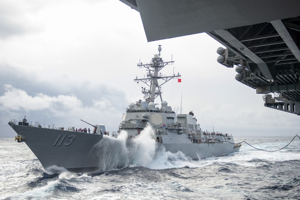 The Arleigh Burke-class guided-missile destroyer USS John Finn approaches the aircraft carrier USS Theodore Roosevelt for a replenishment-at-sea on Jan 14, 2021 in the Indo-Pacific area. Photo: Handout