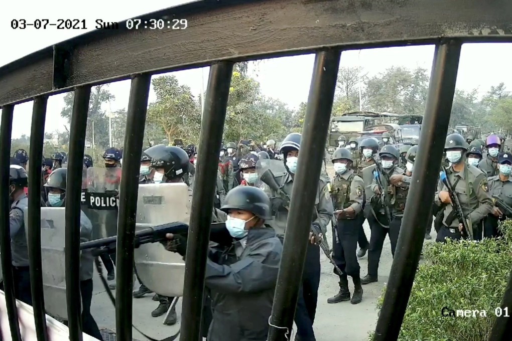 Myanmar security officers wielding shields and guns march towards the site of a protest in Mandalay Technological University in March. Photo: Reuters
