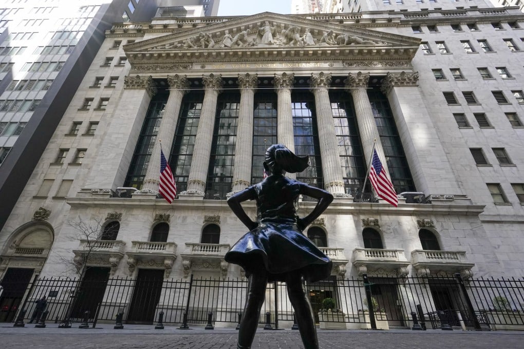 The Fearless Girl statue stands in front of the New York Stock Exchange in New Yorks Financial District. The US will proceed with a law requiring access to audit of foreign companies. Photo: AP