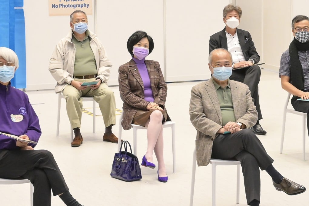 Regina Ip waits for her coronavirus jab, with her handbag beside her. Photo: SCMP Pictures