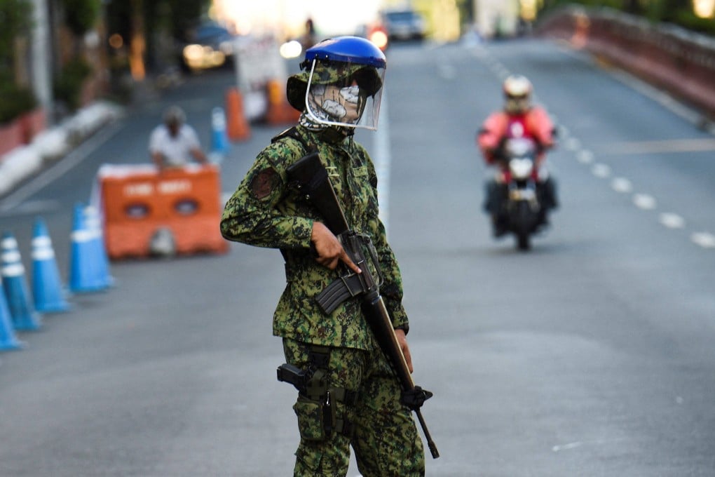 A Philippine policeman stands guard during last year’s lockdown in Metro Manila. Photo: AFP