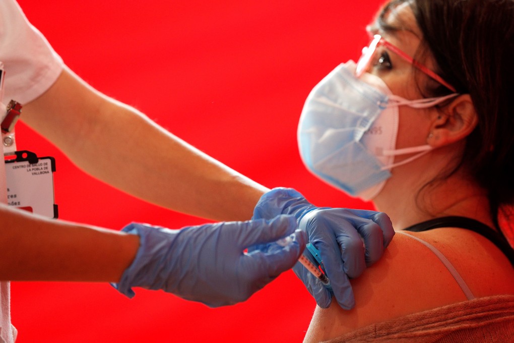 A health worker gives a teacher a dose of the AstraZeneca Covid-19 vaccine in Valencia, Spain. Photo: EPA-EFE