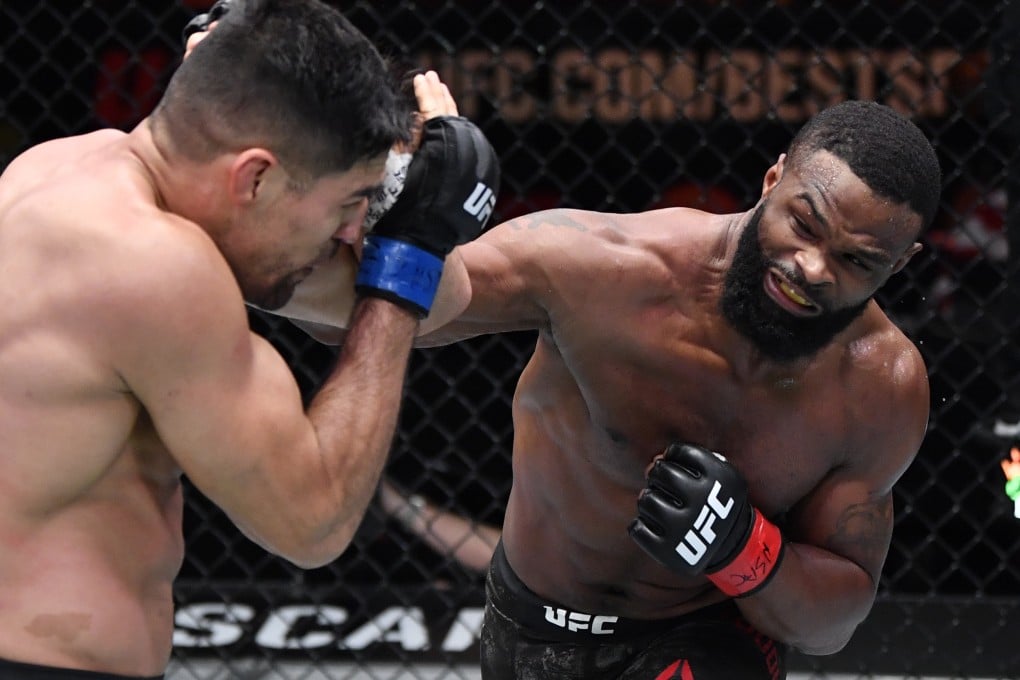 Mar 27, 2021; Las Vegas, NV, USA; Tyron Woodley punches Vicente Luque in their welterweight fight during the UFC 260 event at UFC APEX on March 27, 2021 in Las Vegas, Nevada. Mandatory Credit: Jeff Bottari/Handout Photo via USA TODAY Sports