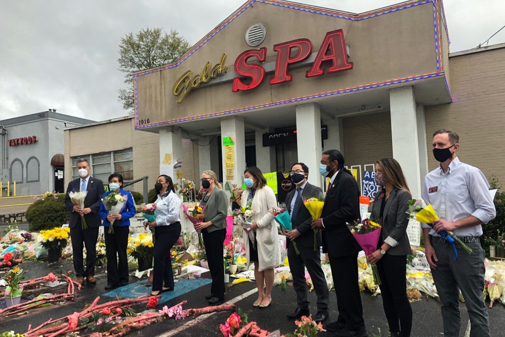 Members of Congress and Georgia state representatives lay flowers outside Gold Spa in Atlanta. Photo: AP