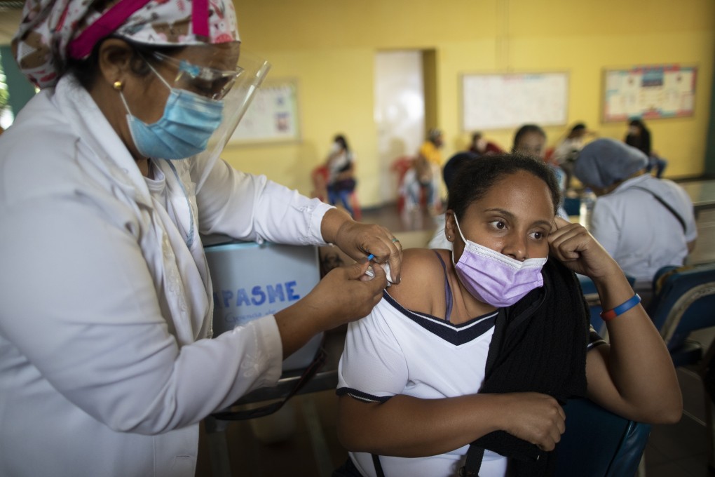 A nurse inoculates a woman with a dose of Sinopharm’s Covid-19 vaccine in Caracas, Venezuela. Photo: AP
