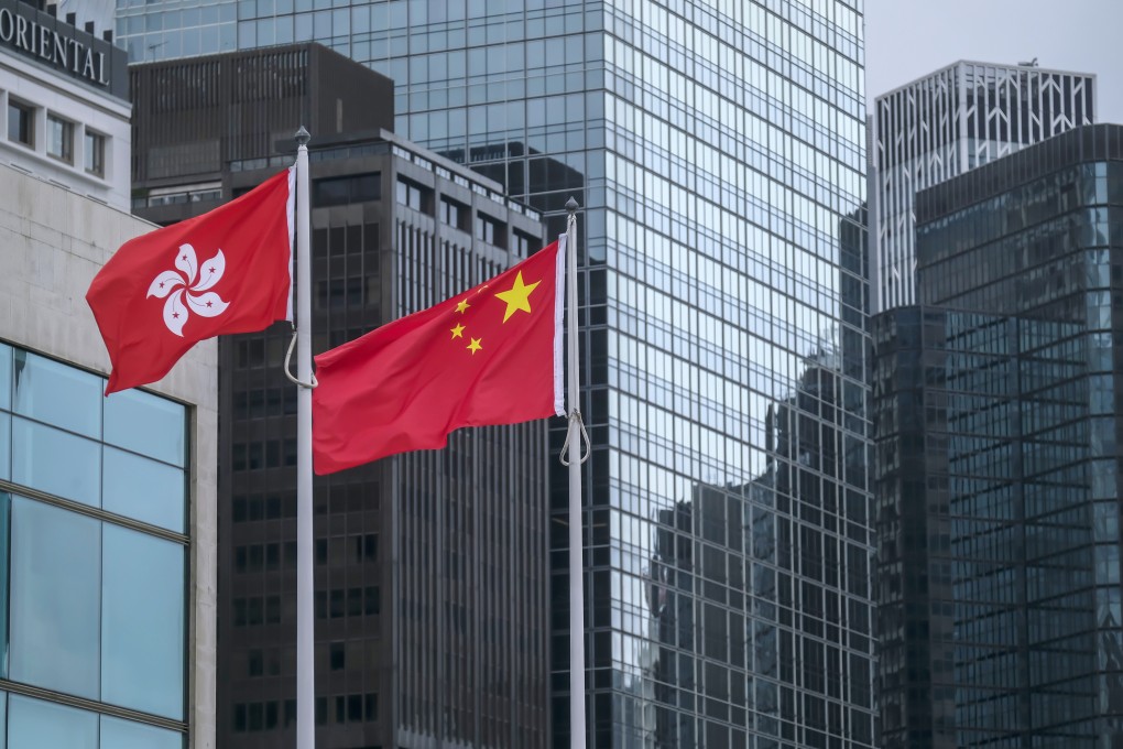 The Chinese national flag (right) and Hong Kong’s. Photo: Bloomberg