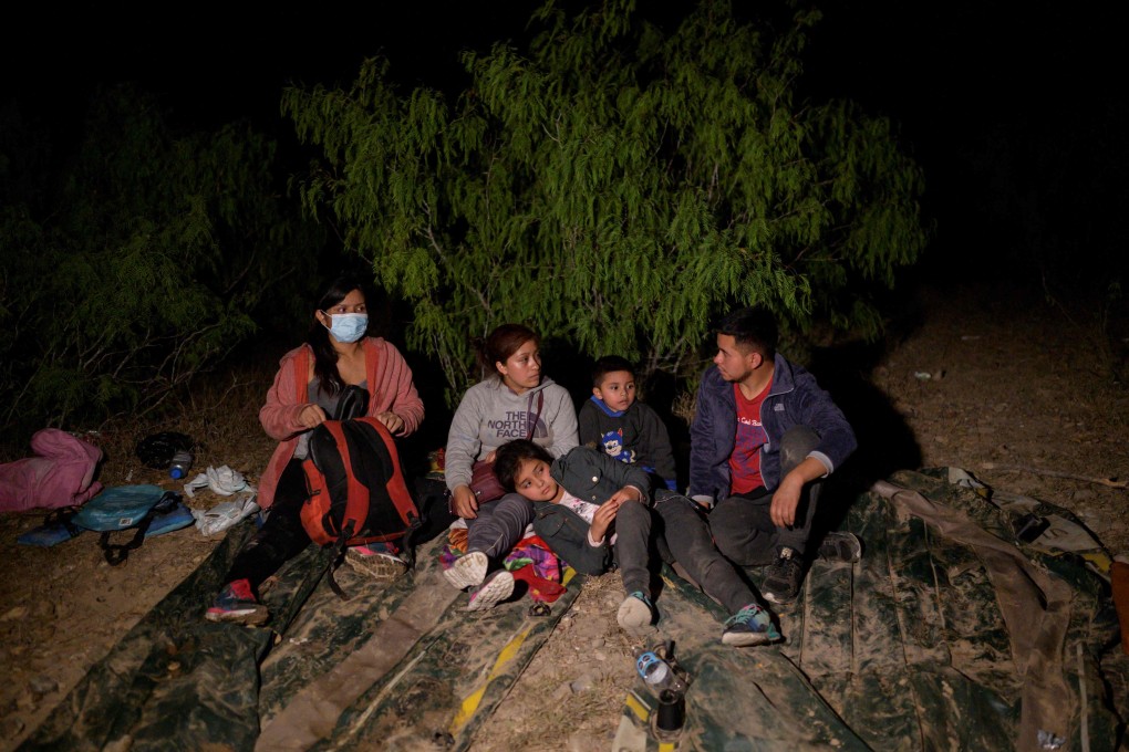 Immigrants from Guatemala, who arrived illegally across the Rio Grande river from Mexico, rest on the US side of the river bank. Photo: AFP