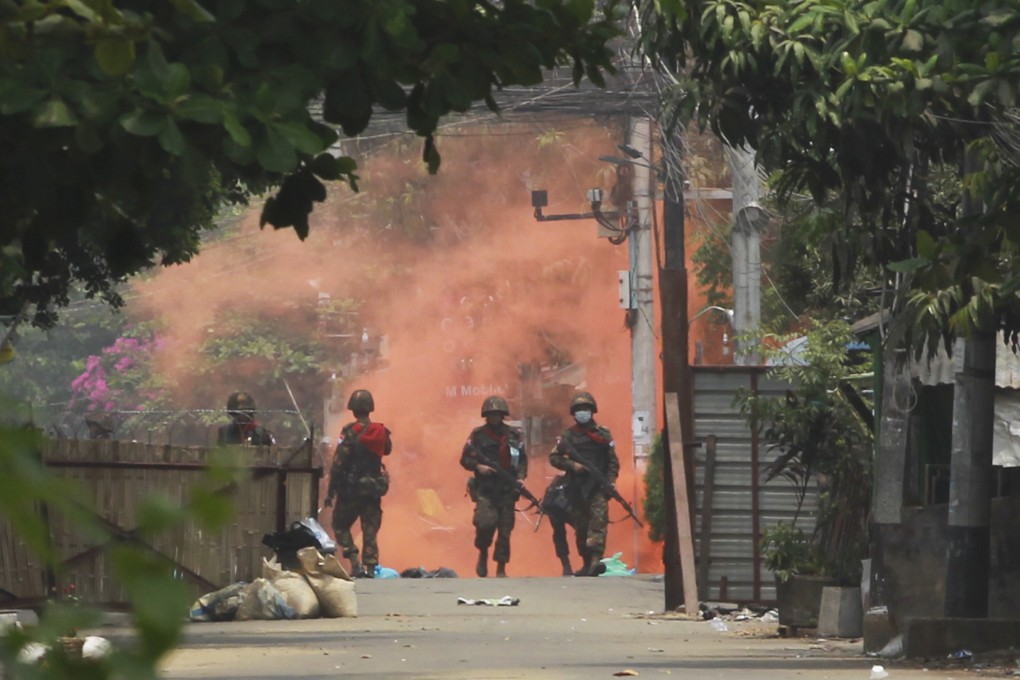 Soldiers walk towards anti-coup protesters during a demonstration in Yangon. Photo: AP