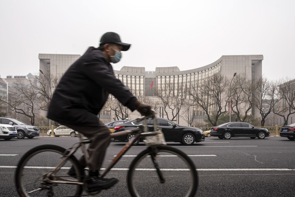 A cyclist rides past the People’s Bank of China building in Beijing. FTSE Russell said on Tuesday it would begin including Chinese government debt in its flagship bond index in October. Photo: Bloomberg