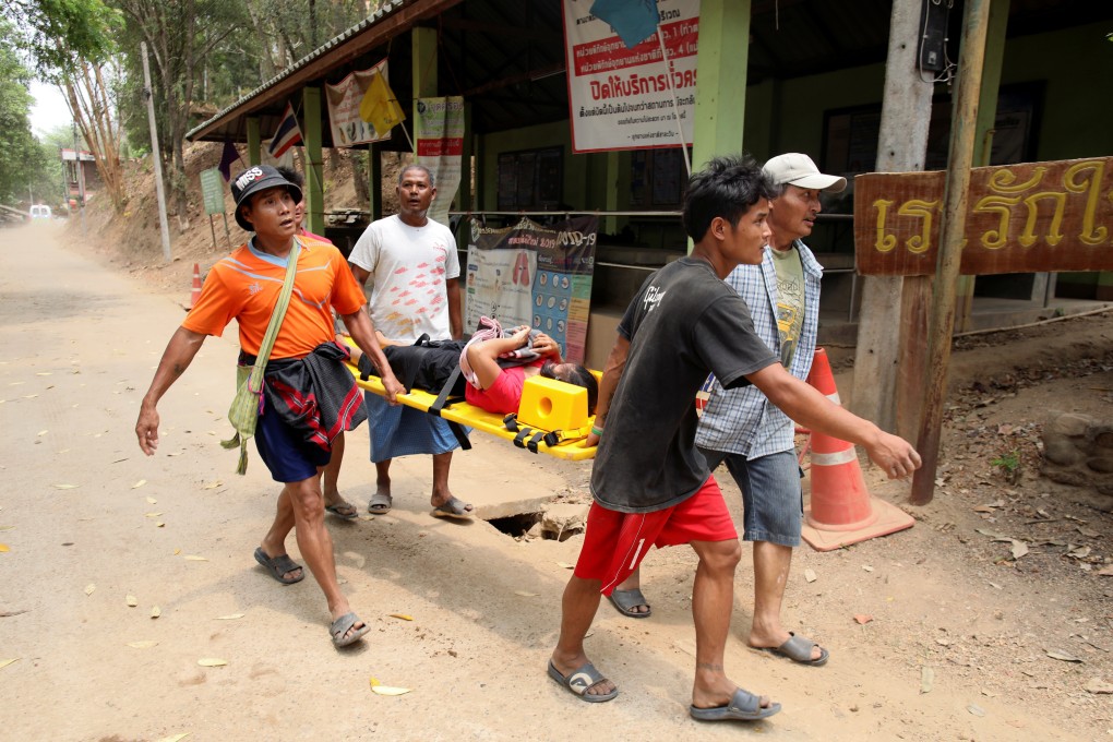 A wounded civilian fleeing the violence in Myanmar is carried on a stretcher to receive medical treatment across the Thai border. Photo: Reuters